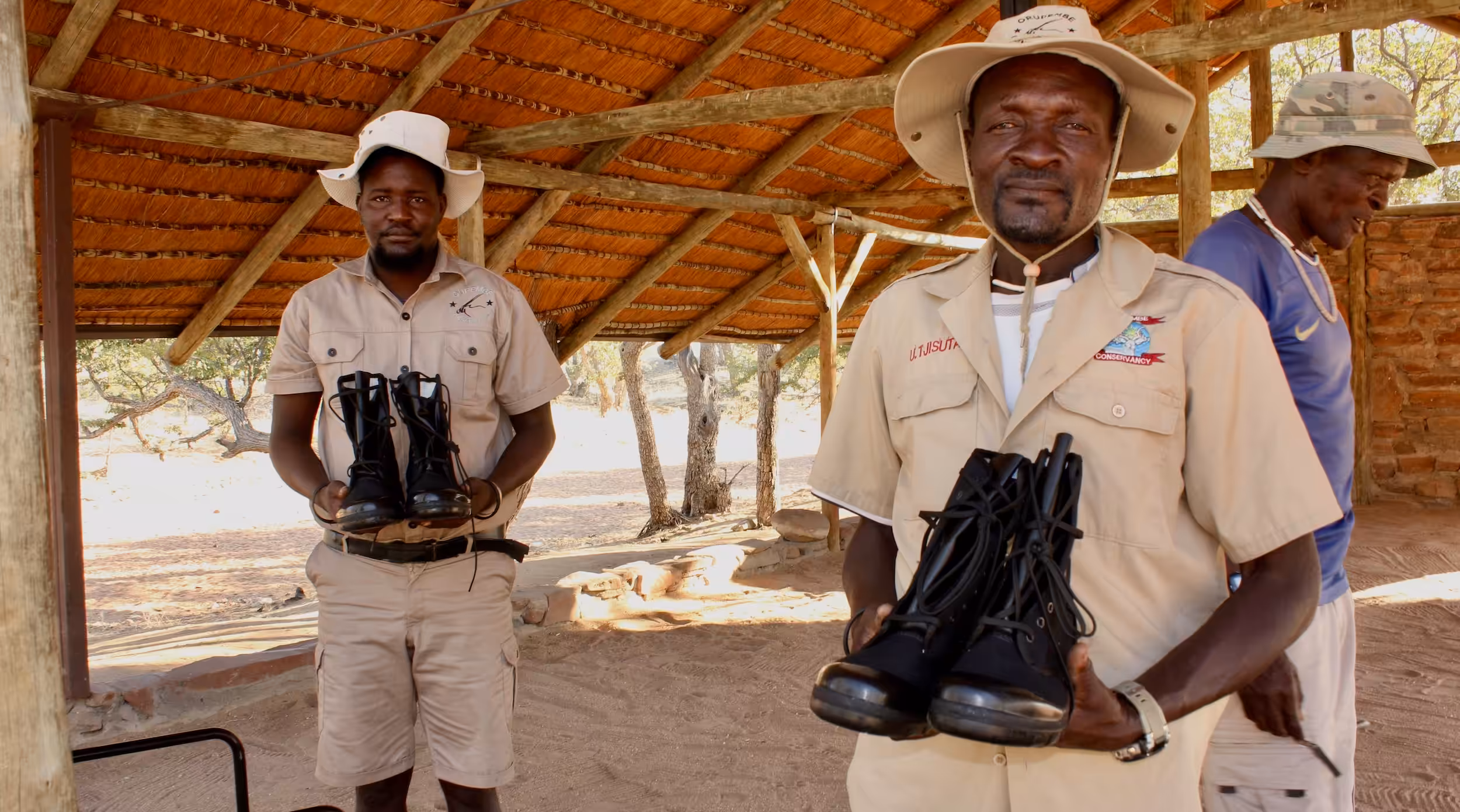 Game guards posing with their newly donated boots.